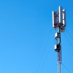 black and white electric post under blue sky during daytime