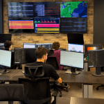 ITcare network operations centre with engineers monitoring ISP and data centre networks on a video wall.