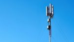 black and white electric post under blue sky during daytime