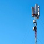 black and white electric post under blue sky during daytime